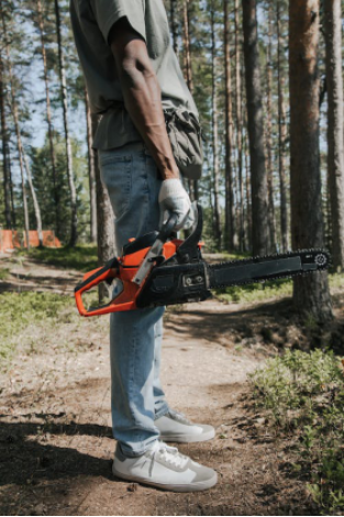 a person holding a chainsaw